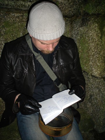 Jonathan Boakes reading the visitors book.